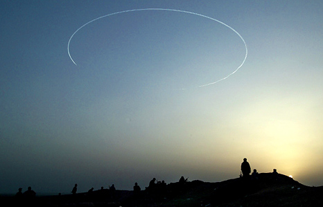 Americans and Kurdish pesh merga troops hold their positions as a B-52 flies overhead, northern Iraq, April 5, 2003.